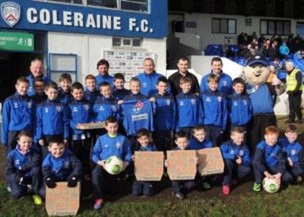 Members of the 2002 and 2004 squad who are heading to Newcastle to play against Newcastle Academy and Wallsend Boys Club receiving sponsorship for training tops from Domino's Coleraine.