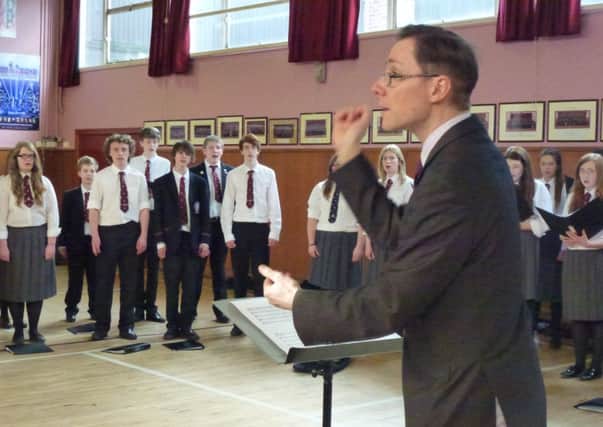 Stuart Barr putting Carrickfergus Grammar School Choir through their paces. INCT 13-751-CON
