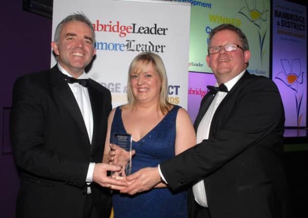 Junior Minister Johnathan Bell and Ian Clarke, Johnston Press, present the Excellence in People Development Award at the Banbridge District Business Awards to Nicola Sexton from Calvin Klein.  INBL1214-BUSAWARDS39