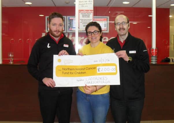 Sorcha Chipperfield, Northern Ireland Cancer Fund for Children fundraiser, is presented with a cheque by Sam Gamble and Andrew Brown, from Ladbrokes. INCT 13-753-CON