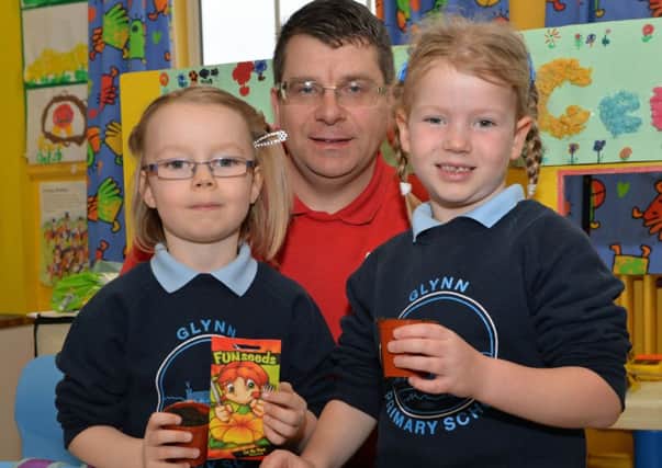 Gary Bissett from Inver Garden Centre helped Rosie and Julia plant seeds at Glynn Primary School. INLT 13-014-PSB