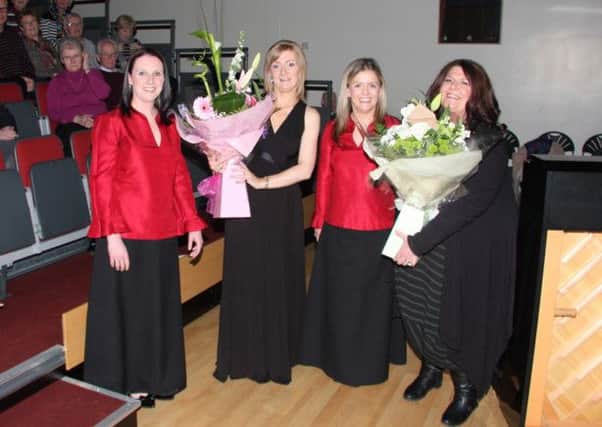 Committee members Dawn Bradshaw and Gayle Ziola present floral arrangements to Sheelagh Greer (Clare Chorale)  and Kim Lenaghan (Compere). INNT 13-511CON
