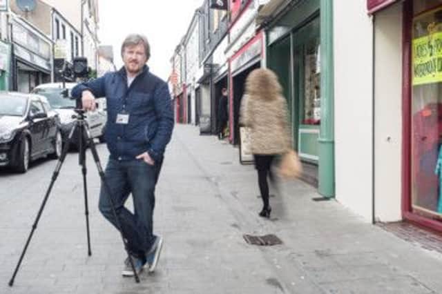 Google Business Photographer John M. Lynch at work in North Street. INCT 13-759-CON