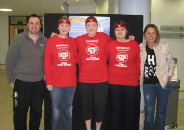 Pictured during the  at the Sports Relief Swimathon are Paul Mawhinney, manager of Carrickfergus Amphitheatre; Sharyn Ingrey; Amy Leathem; Rebecca Parkes and Bea Cox, Carrick Sainsbury's store manager.  INCT 13-734-CON
