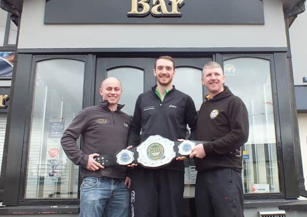 Noel Tierney who claimed his third successive All Ireland Full-contact Kickboxing title is picture with his coach Joe Hagan and Christopher Eastwood of the Dunleath Bar main sponsor of Cookstown Kickboxing Club