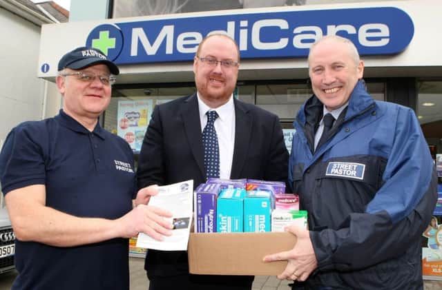 Ryan Catney (centre), area manager of the MediCare Pharmacy Group, presents Brian Mullan (left) and Mark Welsh of Newtownabbey Street Pastors with some first aid supplies. INNT 13-028-FP