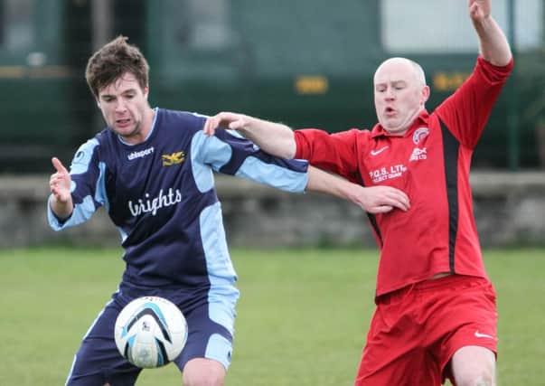 Alan Clarke (left) in action for Whitehead Eagles in the game against Drumbo.