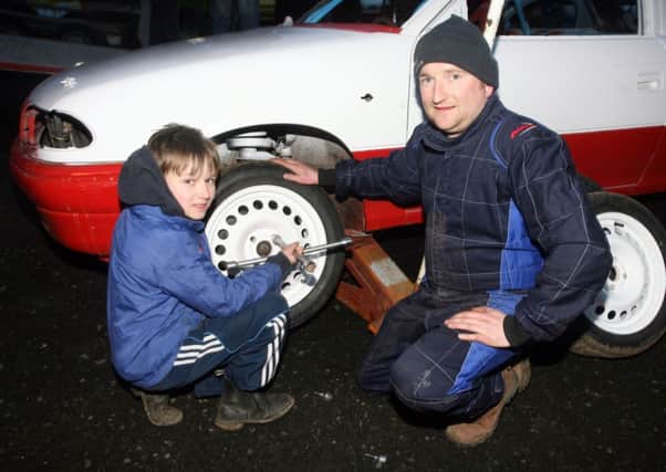 Ashley Graham and young William Hamilton tighten up the wheel nuts at Ballymena Raceway. INBT14-258AC