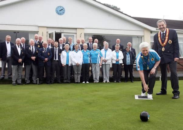 Ballymena Lady President Iris Millar delivers the first bowl of the season to open Ballymena Bowling Club, watched by President John Coulter and club members. INBT14-284AC
