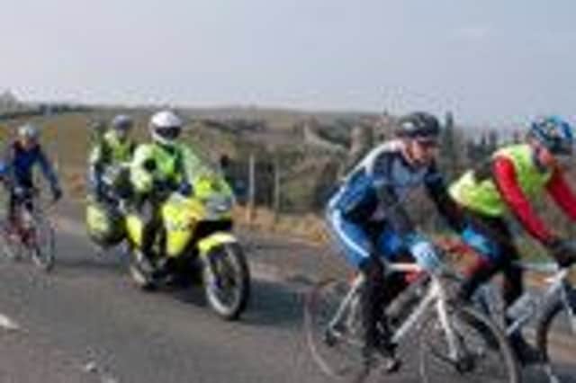 Road Policing Officer joins Bann Wheelers Cycling Club members for a run near to Dunluce Castle.