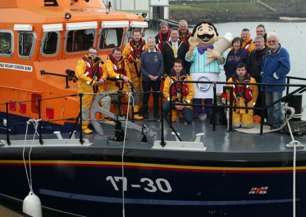 Councillor David Harding, Mayor of Coleraine, pictured with lifeboat crew members and committee at the launch of the RNLI Raft Race. INCR14-249PL