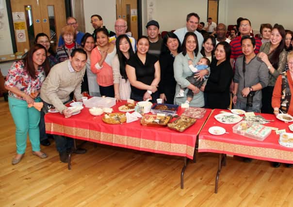 Enjoying the Multi Cultural Forum Pot Luck food sharing event held at the West Bann Development Centre, Coleraine. INCR13-204PL