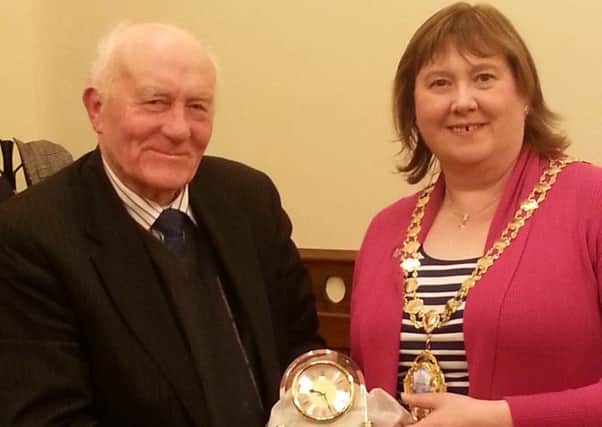 Veteran Ulster Unionist representative Alderman Roy Beggs, who has served on Larne Borough Council for 41 years, is presented with a retirement clock by Mayor Maureen Morrow. Ald Beggs has announced he will not be contesting the election for the new Mid and East Antrim Council on May 22.  INLT 14-686-CON