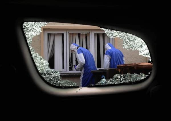 Forensics look at the  damage caused at a house on Ferris Avenu. picture: Colm Lenaghan/Pacemaker