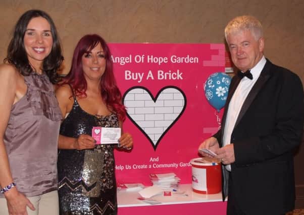 Councillor Stephanie Quigley, Andrea McAlesse organisor and compere Brian Moore at the charity night for the 'Angel of Hope' Memorial Garden in the Lodge Hotel. INCR14-263MP