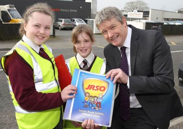 Emilee White and Emma-Jane Lindsay, junior road safety officers at Largymore Primary School, with DOE road safety officer Anthony Crozier taking part in a new initiative to raise awareness of road safety among pupils. US1414-565cd Picture: Cliff Donaldson