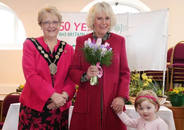 In Hillsborough Courthouse, having been presented with a floral posy at a reception hosted by Lisburn City Council, is HRH the Duchess of Cornwall; the Mayor of Lisburn, Councillor Margaret Tolerton and little Emma Smith, grand-daughter of the Mayor who presented the flowers for the Council's Royal Launch of Hillsborough in Bloom 2014.