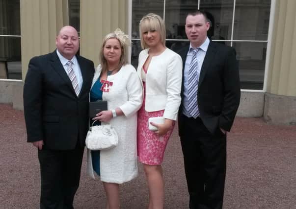 Patricia McQuillan MBE pictured with husband MLA Adrian McQuillan and her son Adam and his girlfriend Dawn at Buckinham Palace last weekend. INCR15-166(S)