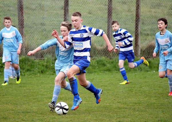 A Northend United under-14 player holds off his Ballymena United opponent during Saturday's match at Smithfield. INBT 15-902H