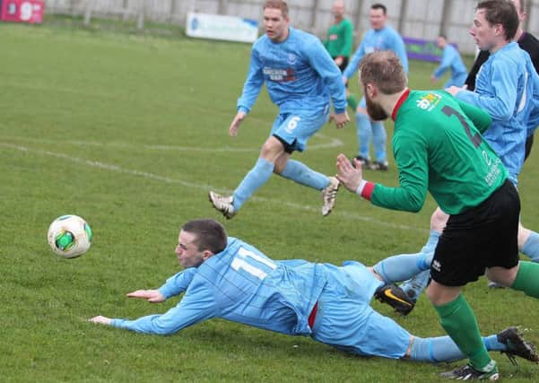 Portstewart's Ryan Doherty is fouled during Saturday's tie with PSNI. INCR15-175MJ