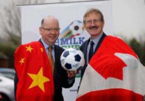 Dale Farm commerical director Stephen Cameron and tournament chairman Victor Leonard celebrate confirmation that China and Canada will compete in the Elite section of the Dale Farm Milk Cup this summer. Picture - Matt Mackey/Presseye.com