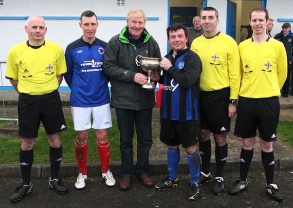 Mr. Jackie Morrison, chairman, North West Junior Football League presents the Supplementary Cup to Barry Gormley, captain, Ardmore Reserves, after their 4-1 victory over Donemana Reserves on Saturday at Wilton Park. Included from left are Victor South, referee, Don Nicholl, captain, Donemana. DER1514MC013