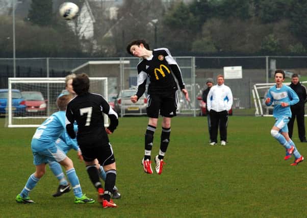 Towering high to send the ball up the pitch was Carniny during their Ballymena United U-14 match. INBT 15-820H
