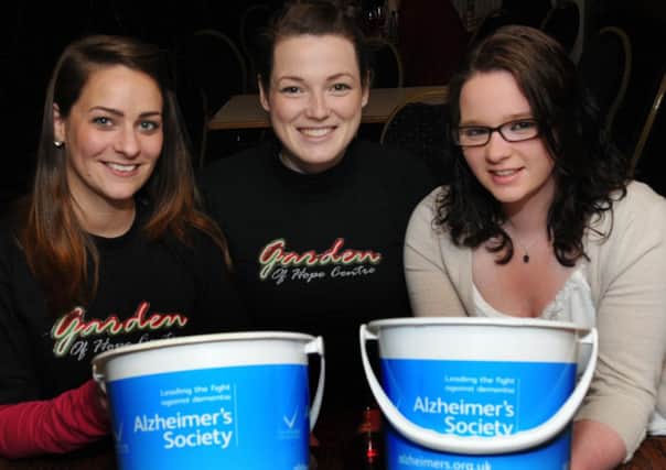 Cookstown Young Farmers members - Lynn Richardson, Emma Jayne Earls and Lindsay Allen - collecting for Alzheimer's Society at the Cookstown YFC 'Mouse Racing' held at the Royal Hotel, Cookstown last year.INMM2013-120ar.