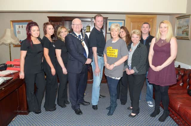 Stewart Johnston, who will be walking from Carrickfergus to Glasgow to raise money for the Cystic Fibrosis Trust, pictured in the Mayor's Parlour with Carrick Mayor  Billy Ashe; CF Trust N.I. regional fundraising manager Linda Alexander; Naomi, Gina, Kerry and Lauren from AboutFace Beauty; Fergie Hall from Kilroot True Blues, fundraising challenge trustee Liz Mellor and Gillian McDowell from the RAOB and Charity Club. INCT 15-301-PR