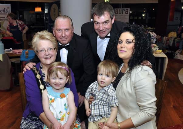 At the "Ladies Evening" in the Island Centre is host Mayor Margaret Tollerton with grandchild Emma Smith, Alfie Wright, Joe Green, Glenn McCartney, and president of Lisburn Chamber of Commerce Belinda O'Neill US1314-405PM Pic by Paul Murphy