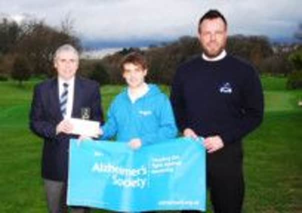 Dunmurry Captain Lawrence Patterson hands over a cheque to Andy Bold of Alzheimers with Dunmurry Golf manager Michael Stanford looking on. The money was raised by members via the 500 Club and Chrismas Draw. Also receiving cheques were the British Heart Foundation, Marie Curie Hospice and Autism. Pic by Michael Forth.