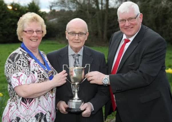 Cecil Marsden (centre), from Ballinderry bowling club, receives the Section A trophy on behalf of his club from Patricia Halliday, league chair, and Roy Kennedy, from sponsor Roy Kennedy Fuels. US1415-501cd Picture: Cliff Donaldson