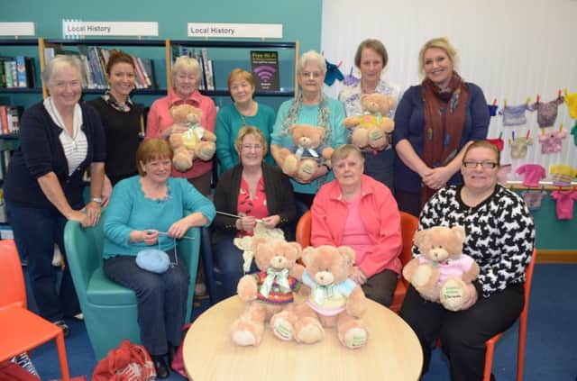 The Knit and Natter group at the Whithead Library busy with their needles for the Dr Barnardo's Barney Bear knitting campaign. With them are Sarah Crowther (back, second left) from the Health and Mind Project, Libraies N.I. and Karen Kerr (back right) from Barnardo's. INCT 16-326-PR
