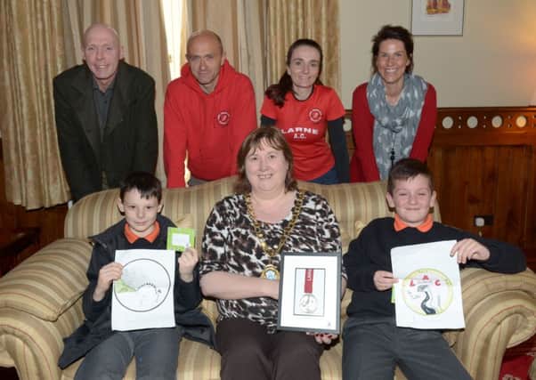 Larne Athletic Club held a competition to design a Half Marathon Medal. Pictured receiving their prizes in the Larne Mayor's Parlour are winner David McCullough (right) and runner-up Clayton White from Linn Primary School.  (also winning a prize was Katie Hogsett from Roddensvale). With them are Larne Mayor Maureen Robinson, parents Carol-Anne McCullough and David White and Billy Thompson and Rhonda Brady from LAC. INLT 16-313-PR