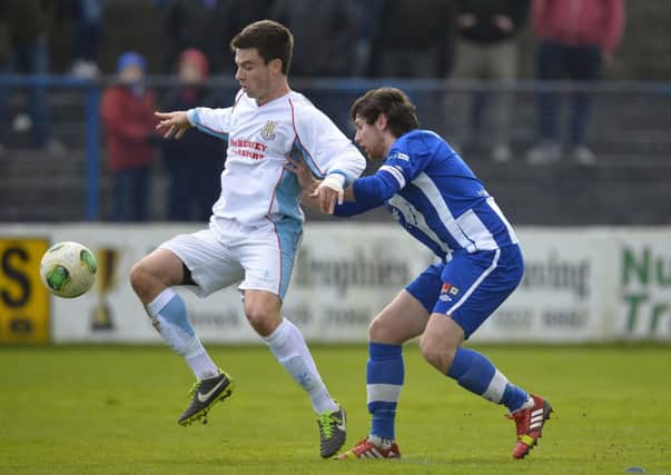 Ballymena United's Mark Kelly shields the ball from Coleraine's Howard Beverland during today's Premiership match at Coleraine Showgrounds. Picture: Press Eye.