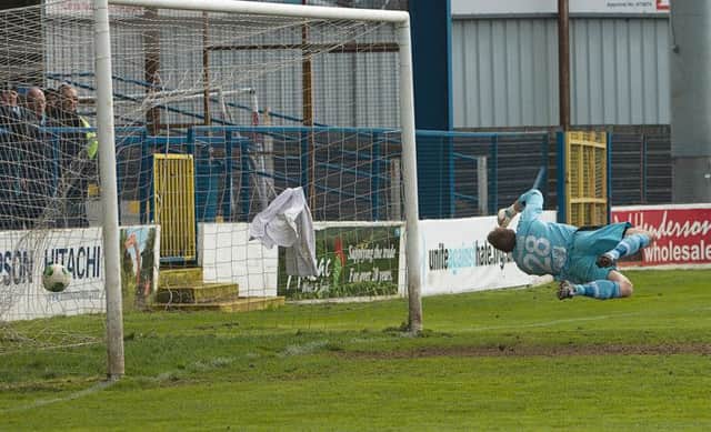 Eoin Bradley's penalty flies past Aaron Shanahan 's despairing dive at Coleraine Showground. PICTURE: Derek Simpson