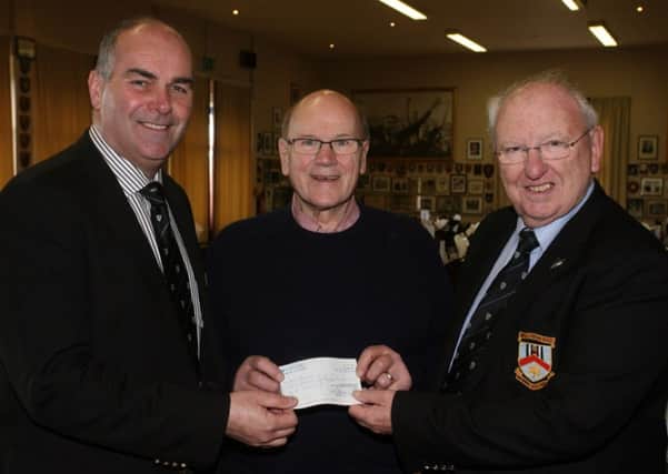 Jimmy McGookin of the NI Hospice, Ballymena Support Group, is pictured receiving a cheque from Derek Montgomery (Chairman Ballymena Barbarian Committee) and Bill Wallace (Chairman), of Ballymena Rugby Club, proceeds of the recent Barbarians match INBT16-273AC