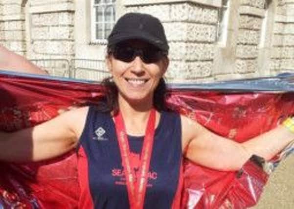 Karen Waring proudly displaying her London Marathon medal.  INCT 16-729-CON