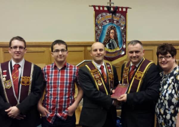 Colin Campbell, second right, who compiled a book to celebrate the Tercentenary of the Formation of the Association of the Apprentice Boys of Derry by Colonel John Mitchelburne. He is pictured presenting the first copy to Kenny Kincaid, President. Also included in the picture are Colin's sons Jordan and Tyler and wife, Joanne.