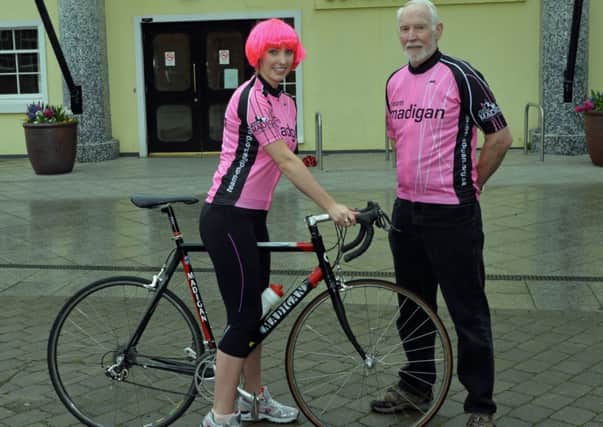 Sarah Davis of Carrickfergus Borough Council and Ronnie McKeegan,  proprietor of Madigan Cycles preparing for the arrival of the Giro D`Italia.