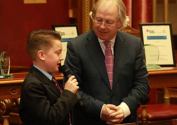 Downshire School pupil John Sloan joins journalist Eamonn Mallie to tell his joke at the Voice Box Award final. INCT 15-701-CON