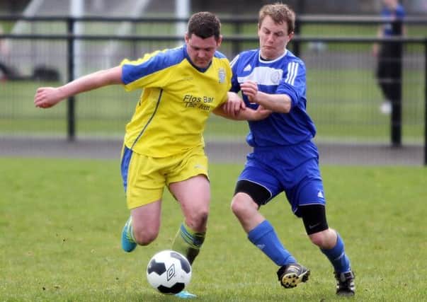 Roe Rovers Reserves' Alan Nicholl and Claudy United's James Canning in action on Saturday. INLV1514-260KDR