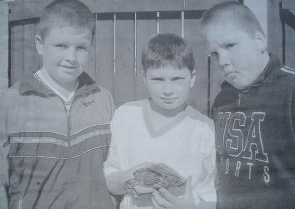 Darren and Ruairi McAlinden and Christopher McConville, from Meadowbrook with the terrapin.