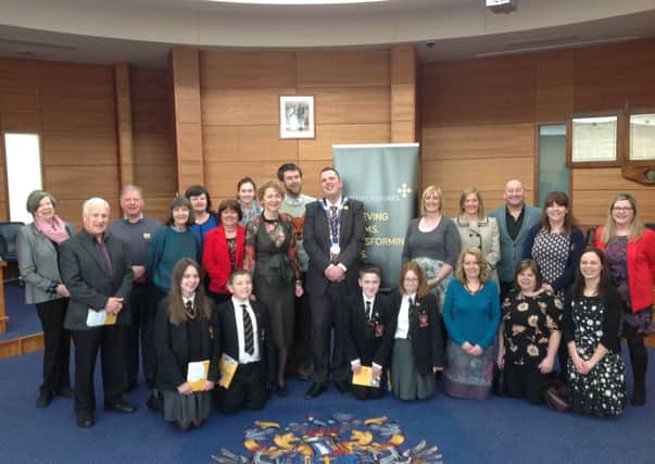 Lisburn's Deputy Mayor Andrew Ewing with Positive Futures Chief Executive Agnes Lunny and those who attended the What About Me event, pictured in the Council chamber.