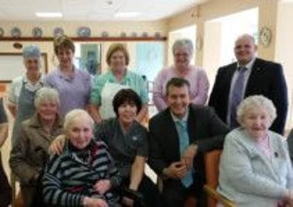 Health Minister Edwin Poots and DUP MLA Ian McCrea pictured with residents and staff at Westlands in Cookstown during their visit on Wednesday,