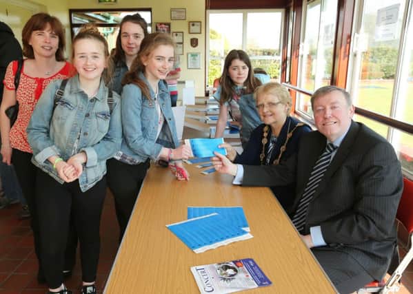 The Mayor of Lisburn City, Councillor Margaret Tolerton and Chairman of the Leisure Services Committee, Alderman Paul Porter with daughter Holly help to distribute the Free Concert in the Park wristbands, which are now available for collection at the Lagan Valley LeisurePlex, Lisburn.