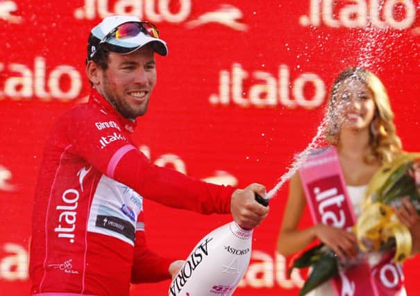 Mark Cavendish at last years Giro wearing the Maglia Rossa, the jersey worn by the leader of the points classification in the race.