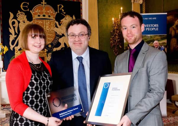 Ballyhenry Primary School has received a prestigious Investors in People Award.Minister for Employment and Learning Dr Stephen Farry congratulated those receiving the business award at a celebration event held in Hillsborough Castle. Pictured with the minister are Robert Smith and Pamela Collins, from Ballyhenry Primary School. INNT 17-451-CON