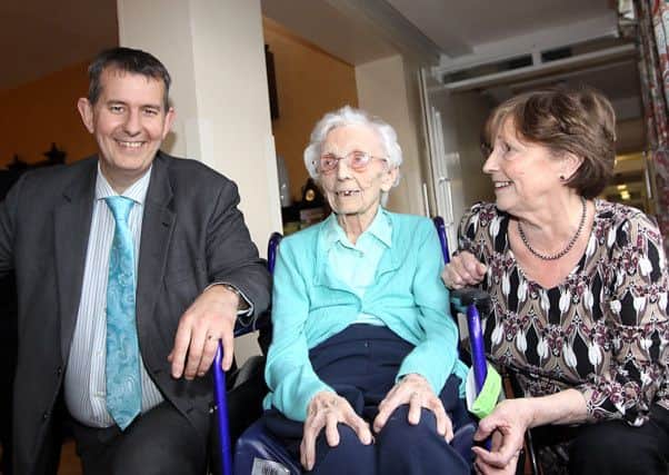 Health Minister Edwin Poots pictured with 100-year-old Thackeray Place resident Lettie and daughter Josie McCann. INLV1614-130KDR