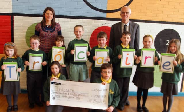 SPELLING IT OUT. Pictured are pupils from St Brigid's PS along with Principal Malachy Conlan and Teacher Aileen McIlroy, who raised the sum of £790.47 for Trocaire.INBM18-14 020SC.